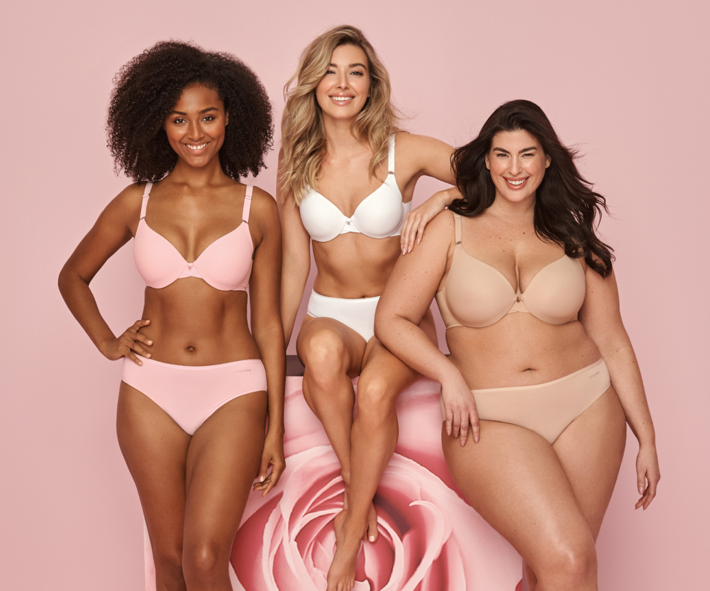 3 models wearing bra-and-panties sets in pale pink, white, and beige