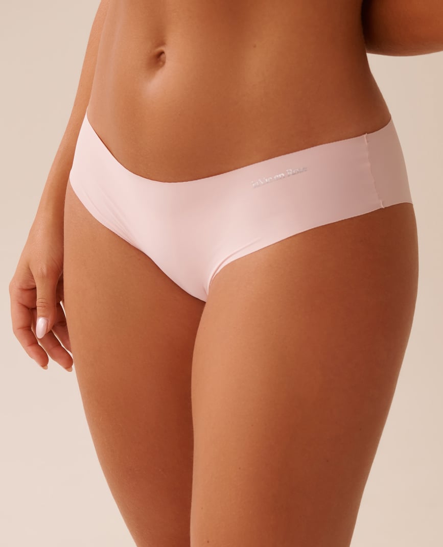 Back view of black panties with pink polka dots worn by model.