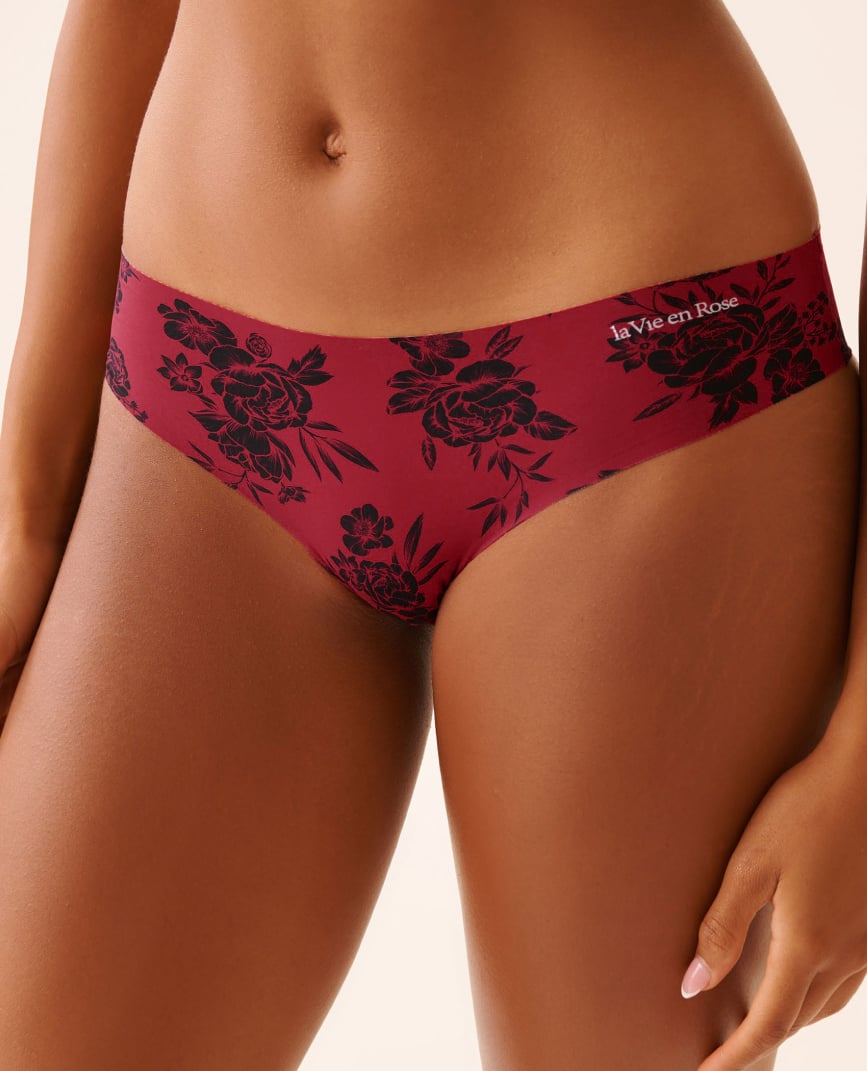 Model shown from the front wearing red panties with black floral patterns.