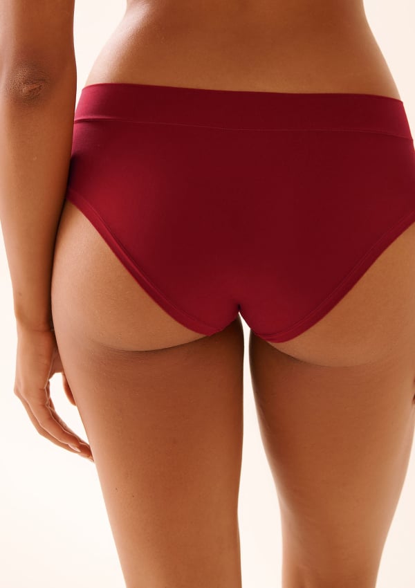 Model shown from the back wearing red panties.