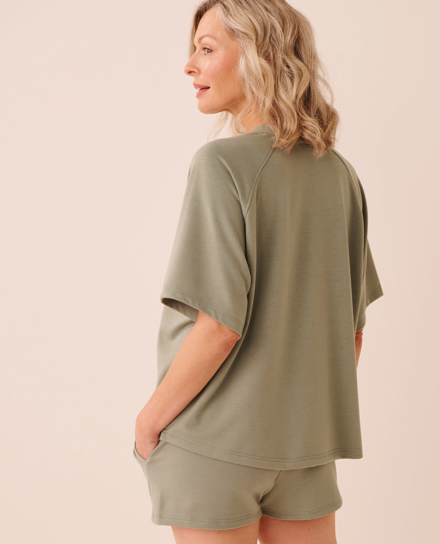 Model wearing a black hoodie from the Body Mind Soul collection.