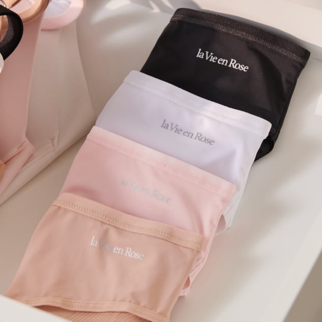 four pairs of neutral-coloured panties, folded