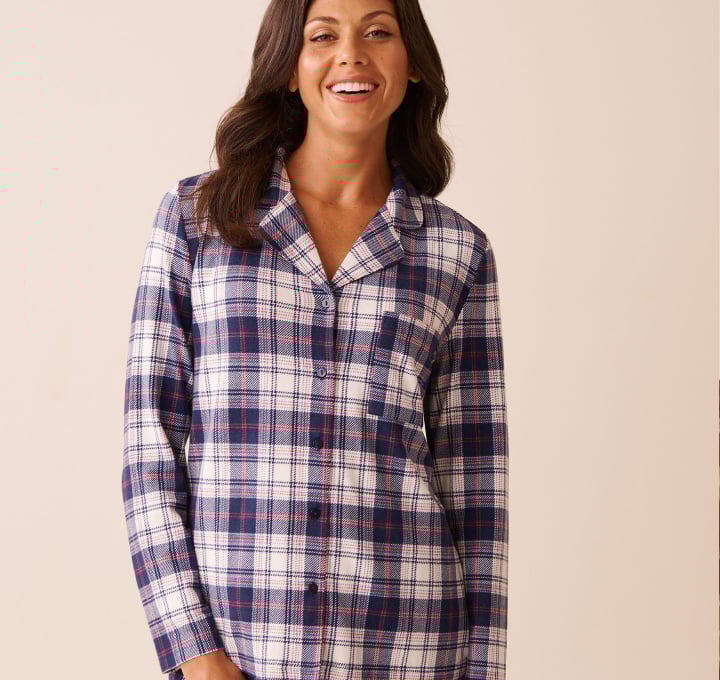 Model wearing blue plaid pajamas made from our cozy sweater knit fabric.