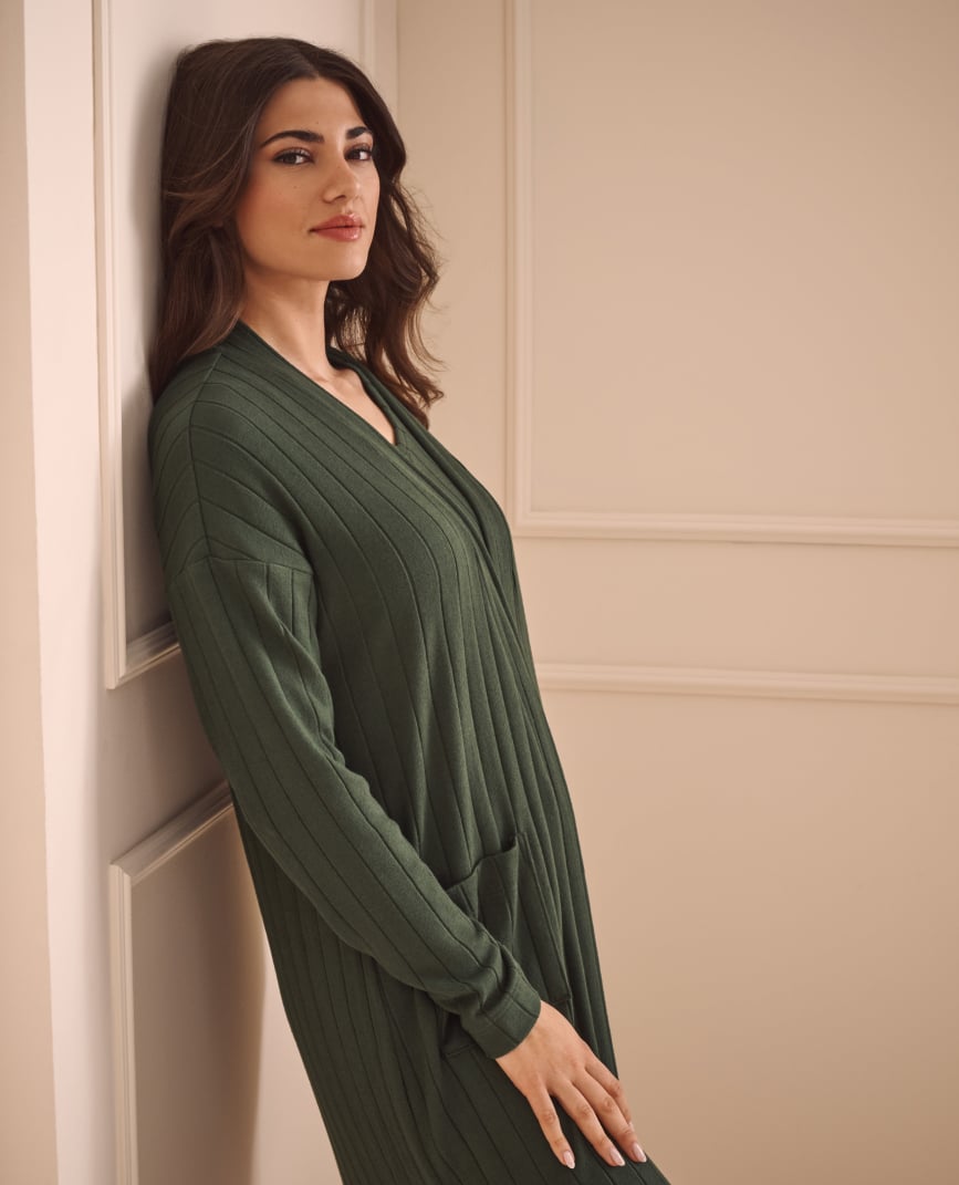 Model wearing a dark green ribbed loungewear kimono.