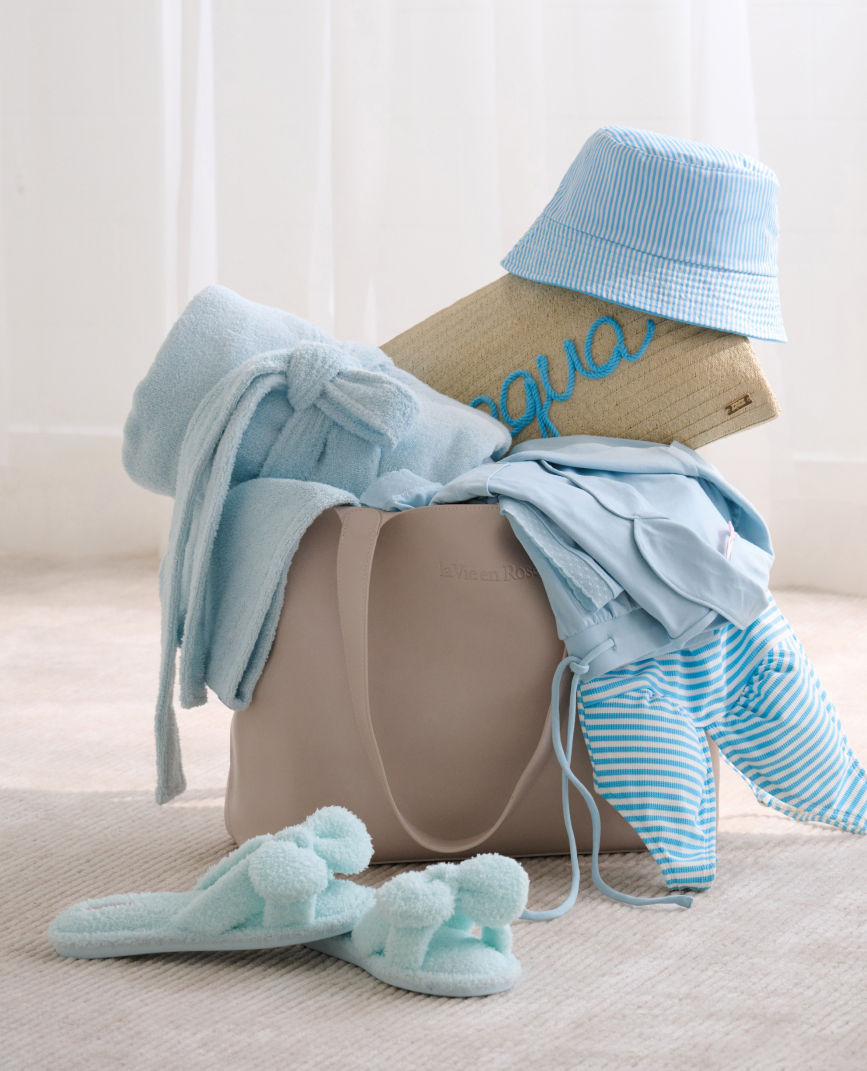 Model back view in black lace bodysuit with open back and satin bow.