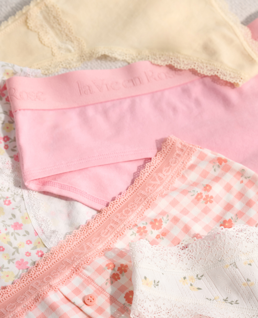 Model in teal satin floral lingerie set: camisole, pants, and kimono.