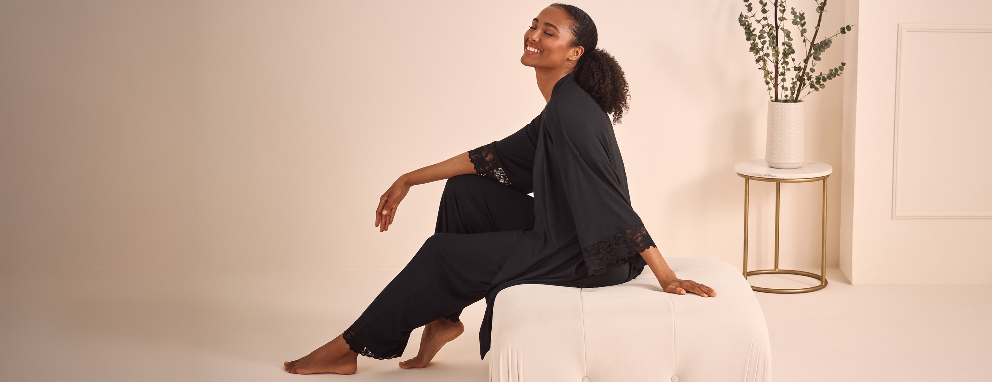 Model wearing a black modal kimono with matching pants	