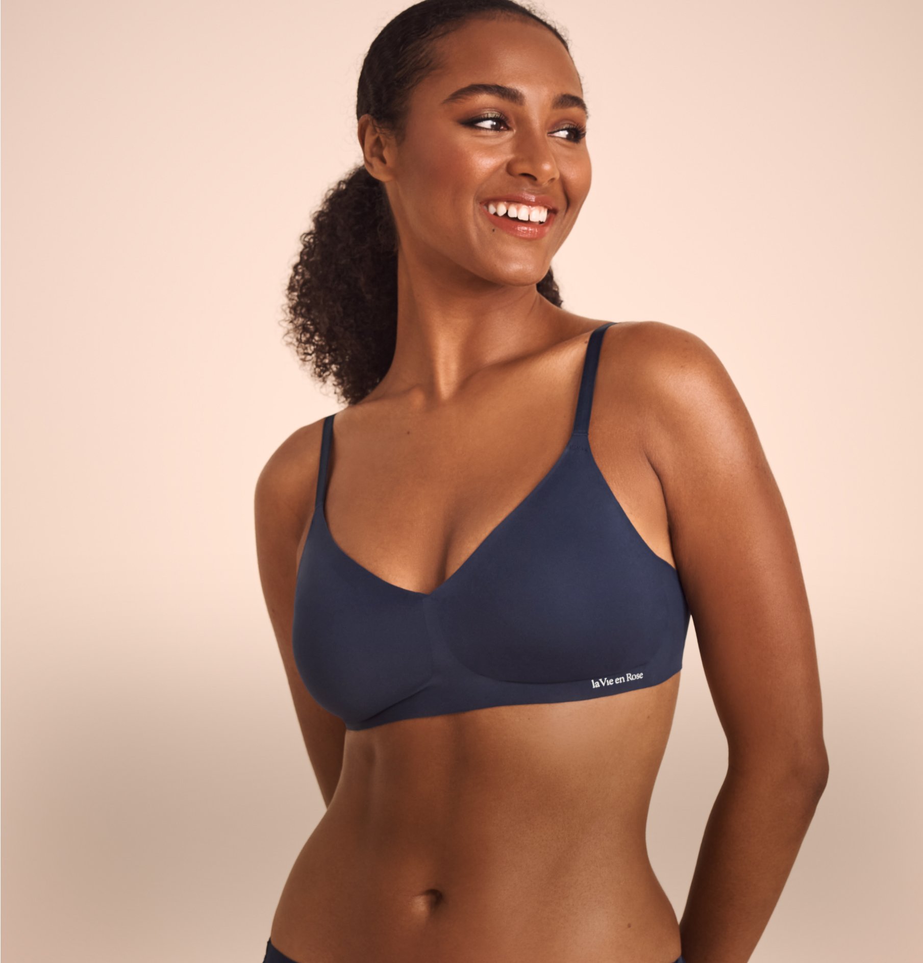 Model wearing a dark blue lounge bra with a relaxed