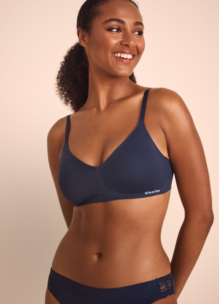 Model wearing a dark blue lounge bra with a relaxed