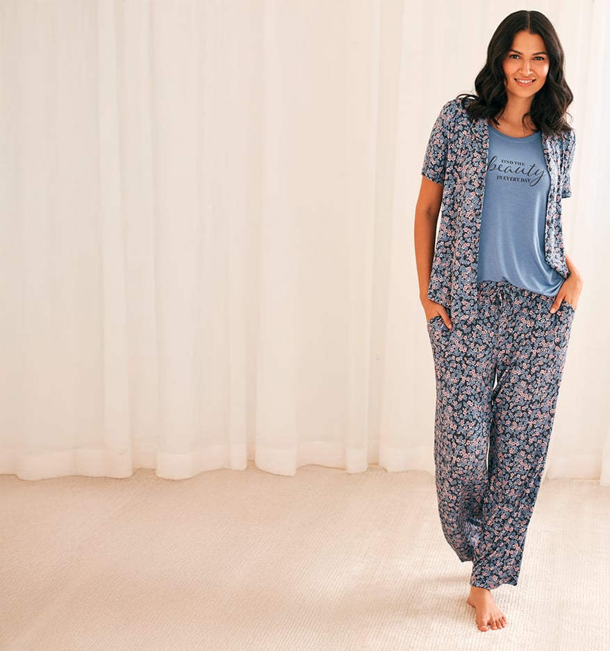 Model wearing a blue floral pajamas set with a graphic tee