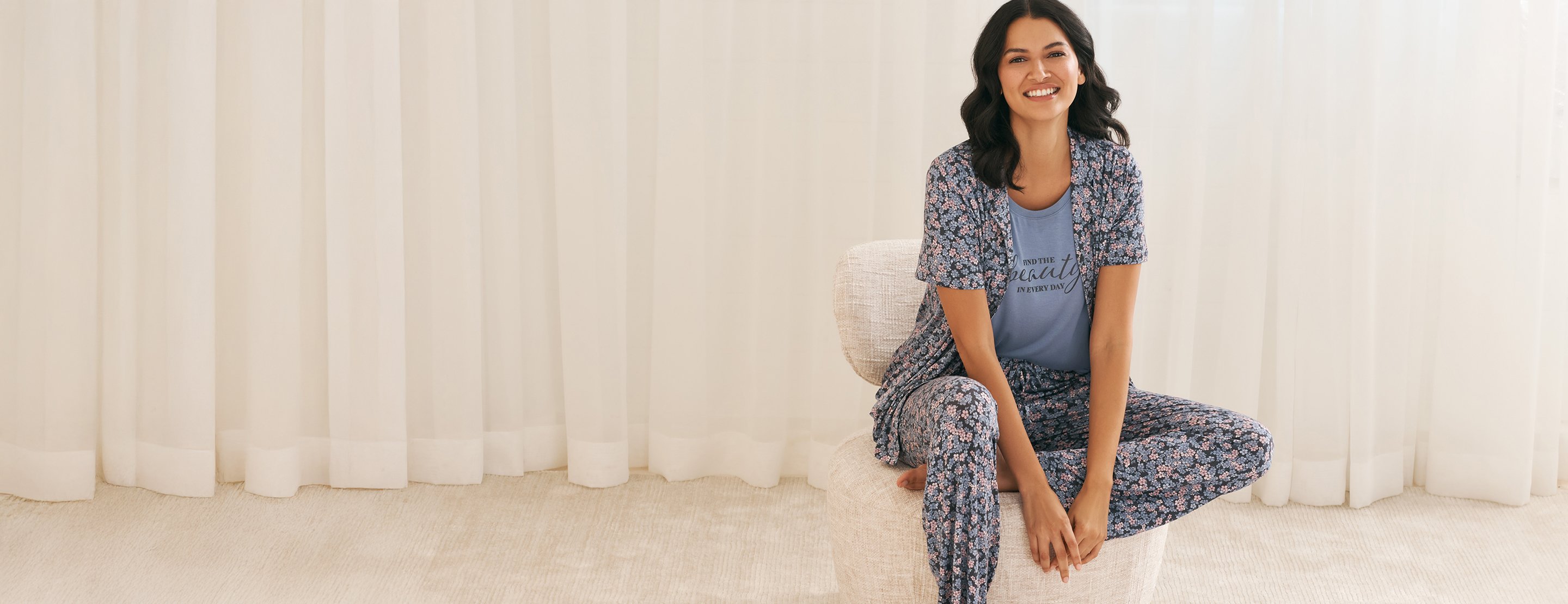 Model wearing a blue floral pajamas set with a graphic tee