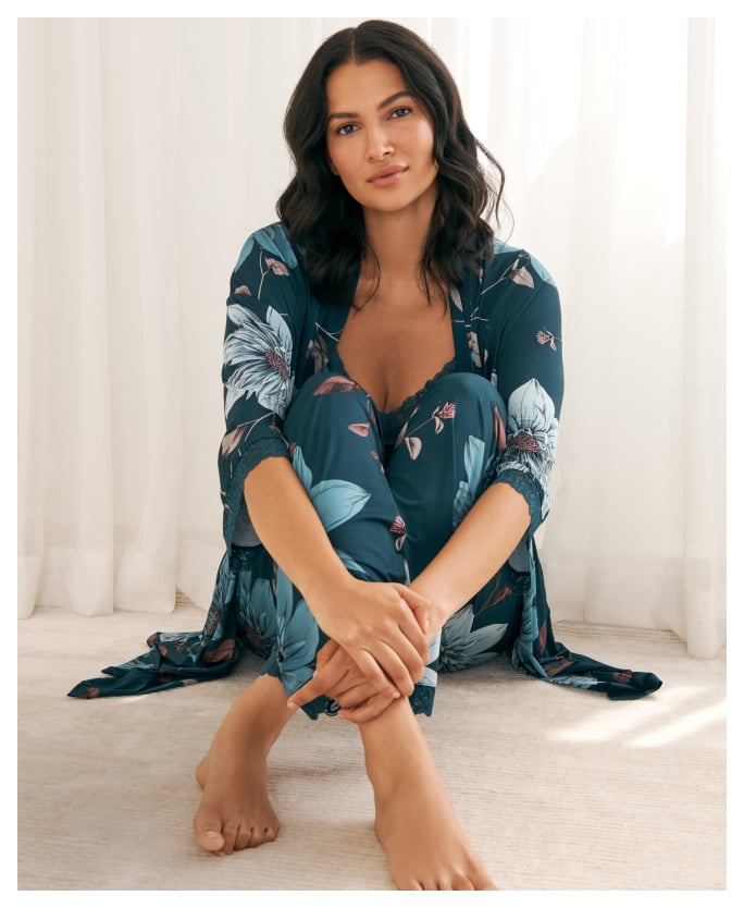 Model wearing a teal floral lace kimono, camisole, and pants lingerie set
