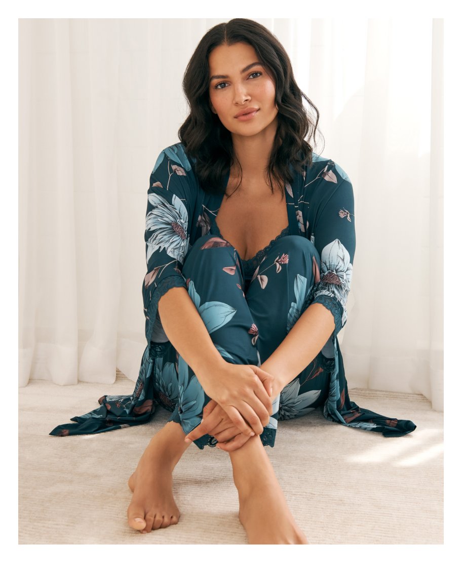Model wearing a teal floral lace kimono, camisole, and pants lingerie set