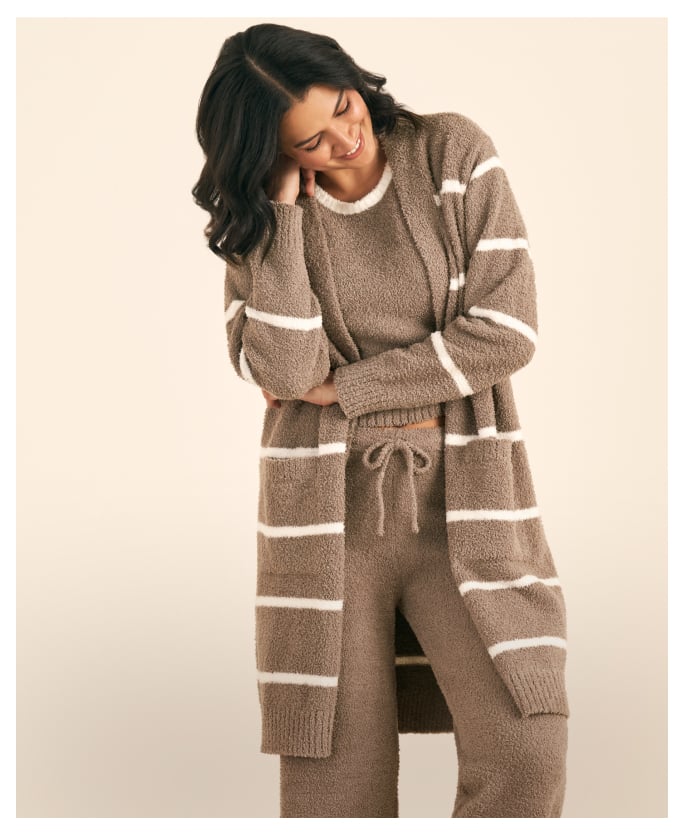 Model wearing a brown lounge set with white stripes, long cardigan, and drawstring pants.