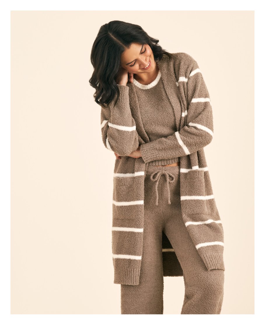 Model wearing a brown lounge set with white stripes, long cardigan, and drawstring pants.