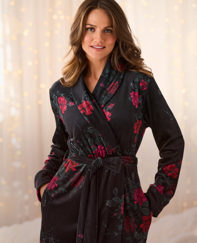 Plush pink, grey and white robes hanging on hangers