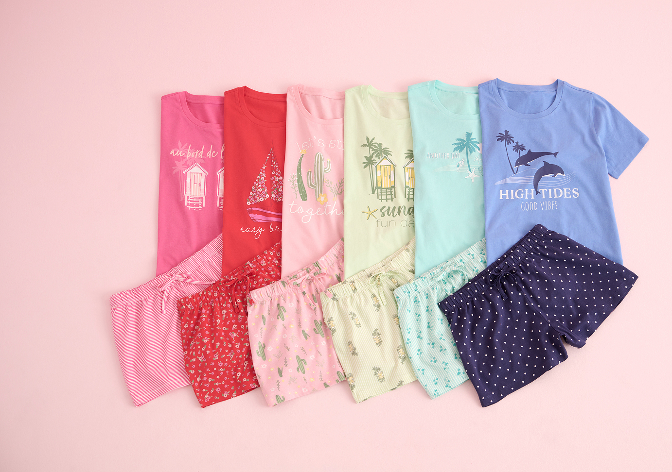 Several pairs of pajamas in various colors from the outlet sale, folded