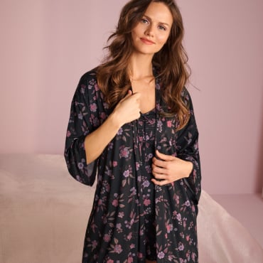Model wearing a black kimono with purple flowers