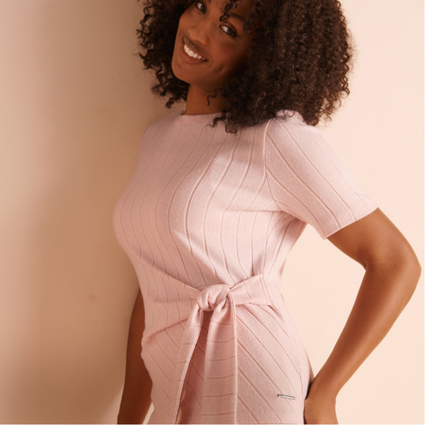 Model wearing a pale pink ribbed loungewear top
