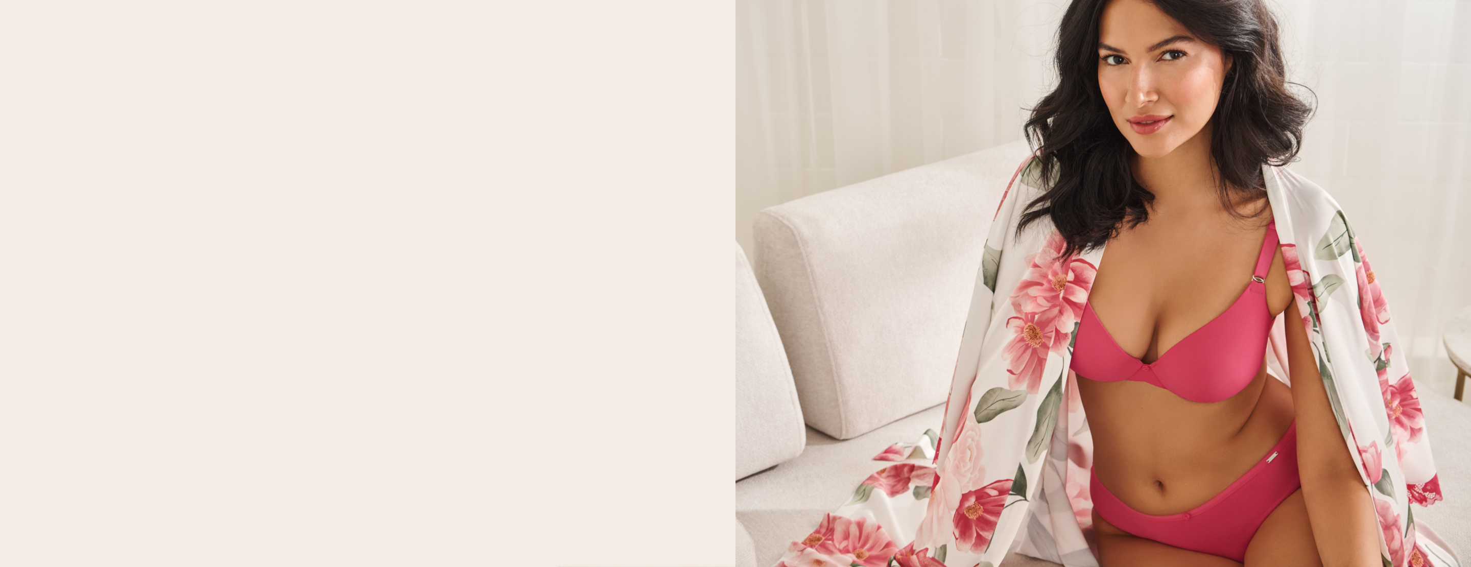 Model wearing a dark pink bra and panties and a white satin kimono with pink flowers draped over her shoulders