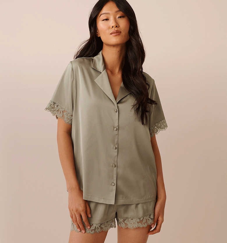 Model wearing sage green satin pajamas