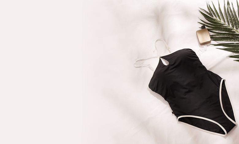 A black one-piece with white outlines laying on the floor