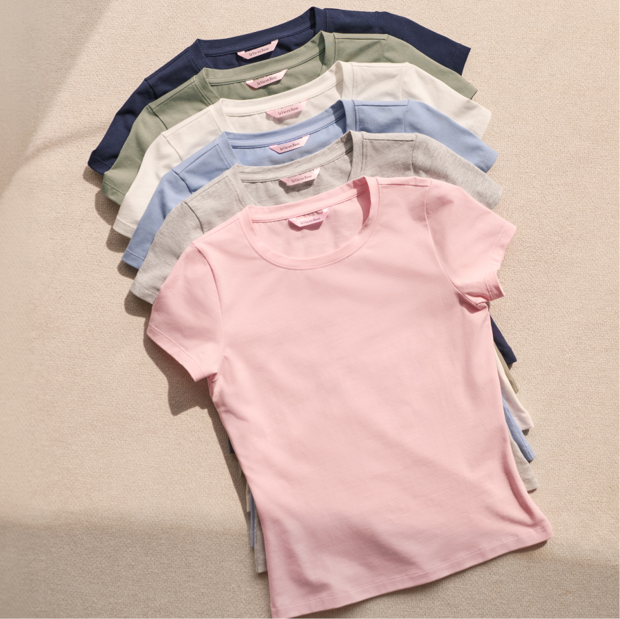 A pile of pastel-coloured T-shirts