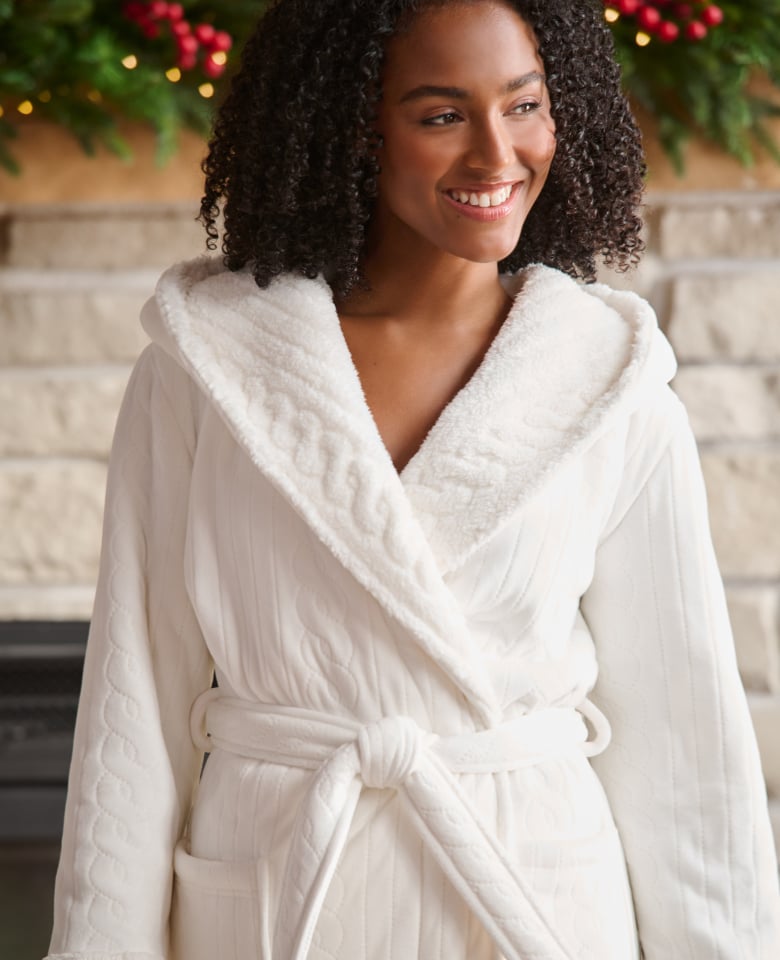 Model wearing a white plush robe.