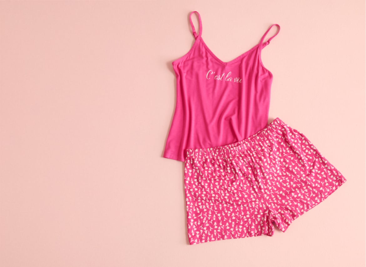 Pink cami and floral shorts laid flat.