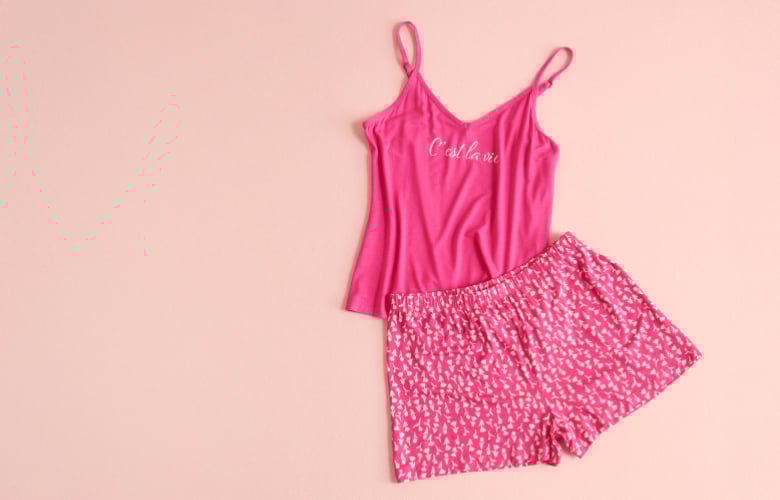 Pink cami and floral shorts laid flat.