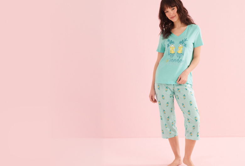 Model wearing a turquoise T-shirt and capri pants set