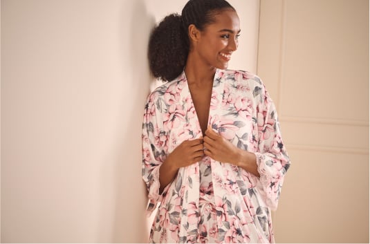 Model in white kimono, camisole and shorts with pale pink floral print