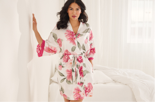 Mannequin wearing a white satin kimono with large pink flowers