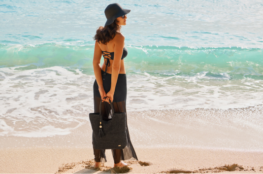 Model in a black beach outfit