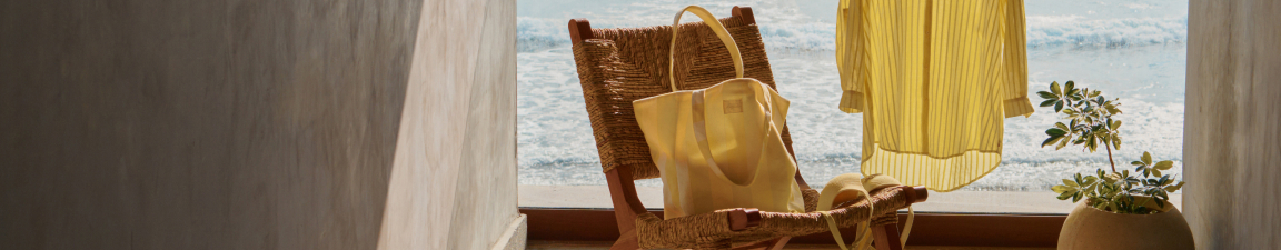 Model wearing a white textured tankini and matching swim bottoms
