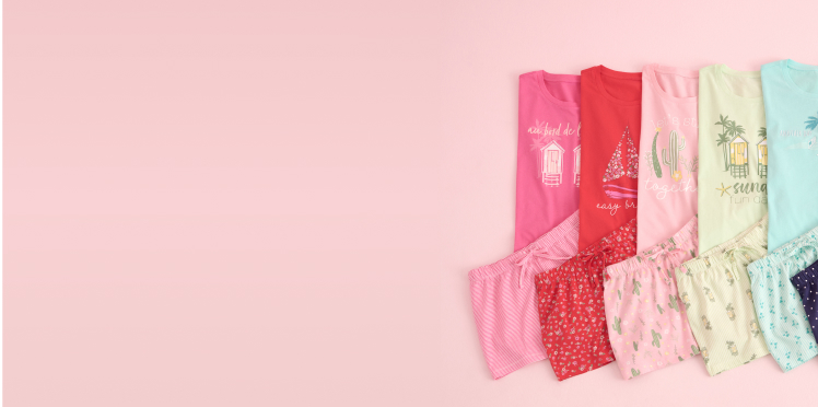 Several pairs of pajamas in various colors from the outlet sale, folded