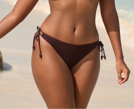 Model wearing a black bikini bottom.