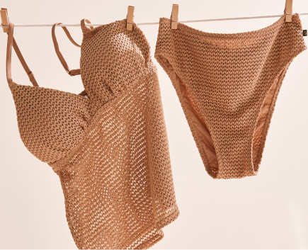 Brown textured tankini and matching bottoms, hanging on a line to dry