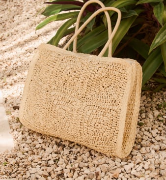 Black straw hat with black bow, seen from behind.