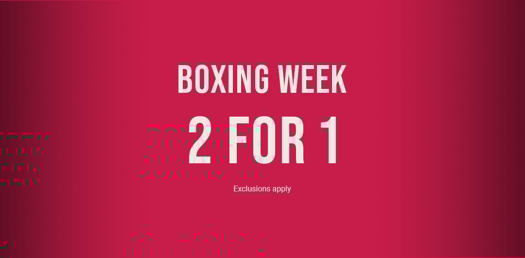 Plush bathrobes in soft tones, folded or tied.