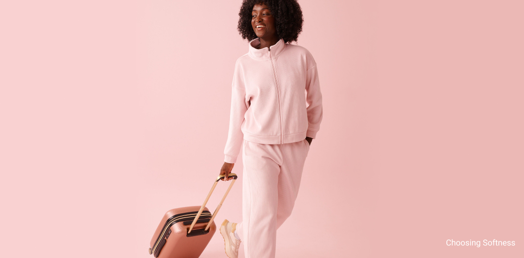 Plush bathrobes in soft tones, folded or tied.