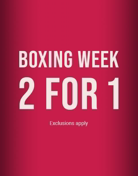 Model seen from behind wearing a textured pink bodysuit with an open back and a large bow at the waist.