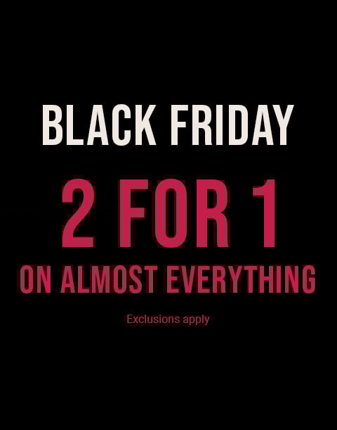 Model seen from behind wearing a textured pink bodysuit with an open back and a large bow at the waist.