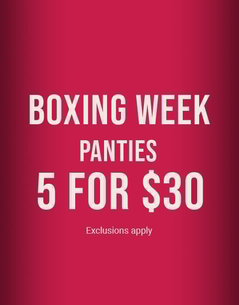 Model wearing a navy lace bra with matching strappy panty