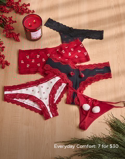 Model wearing a navy lace bra with matching strappy panty