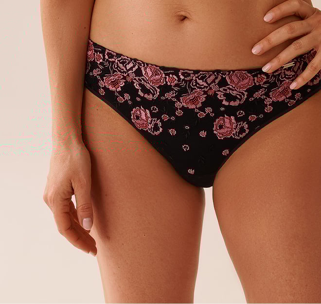 Black mesh panty with pink floral patterns.