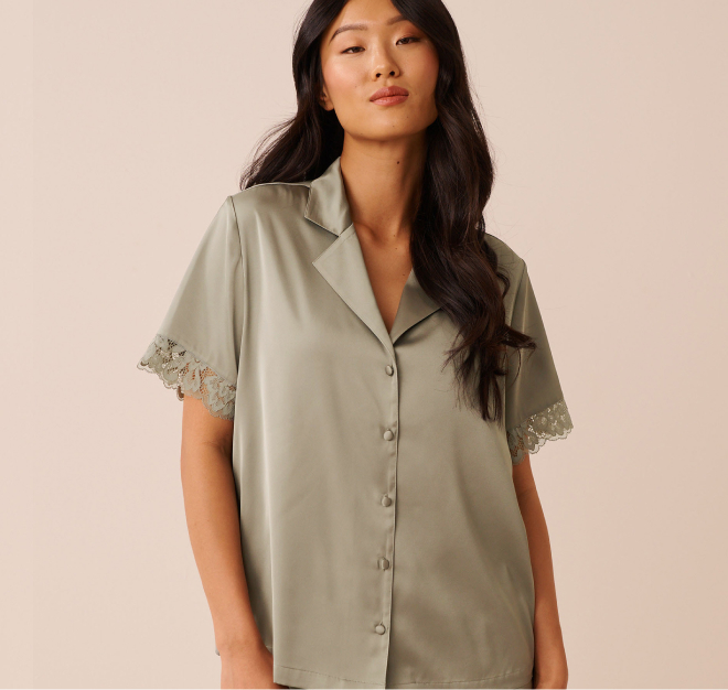 Model wearing sage green satin pajamas