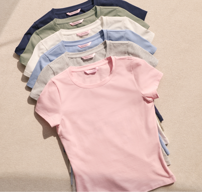 A pile of pastel-coloured T-shirts