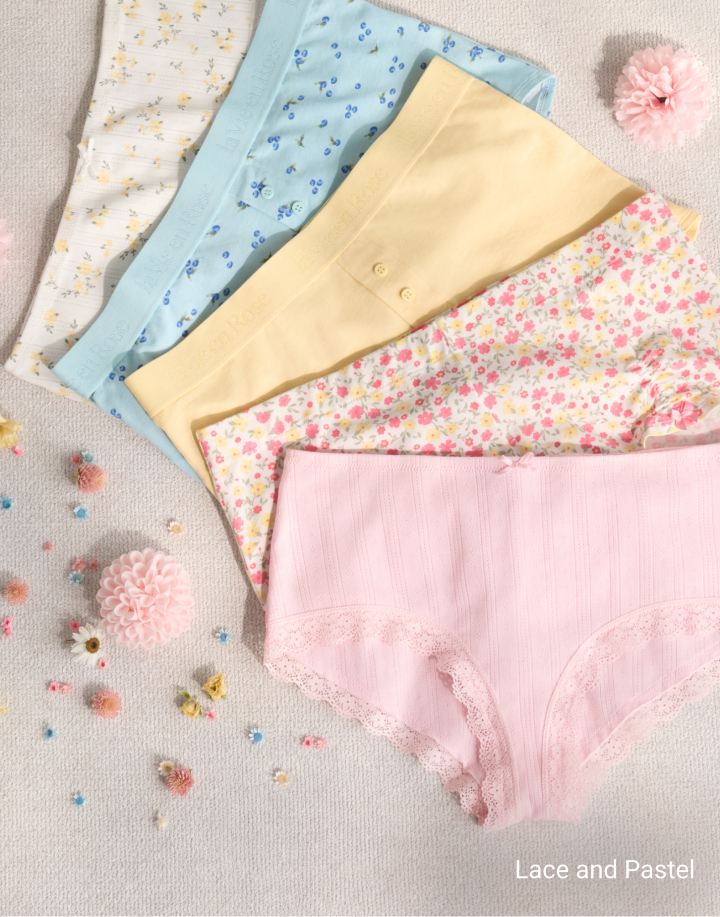 Model wearing a navy lace bra with matching strappy panty